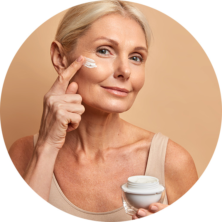mature lady applying skin cream