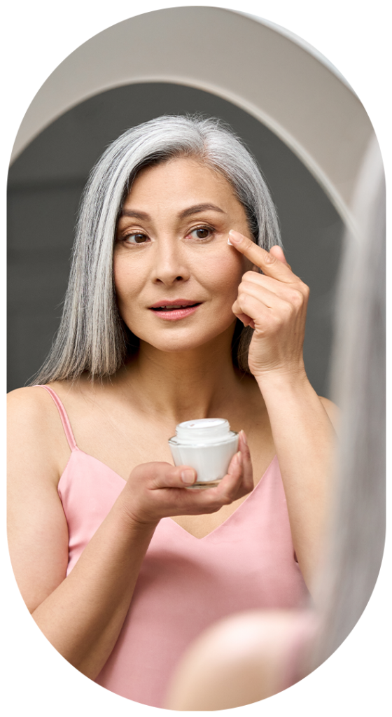 mature lady applying skin cream