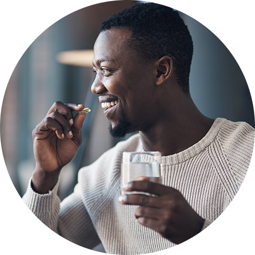 Happy man taking medicine