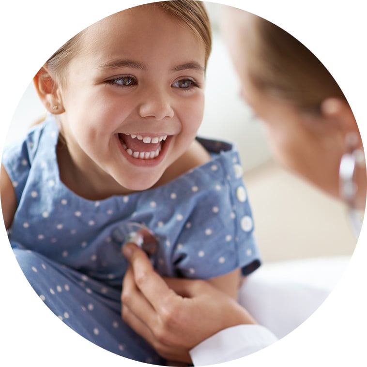 Pediatrician treating happy little girl